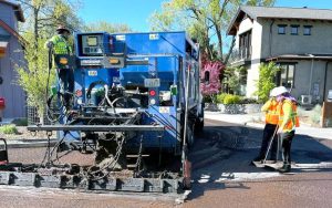 Workers apply a slurry seal in Ashland in 2022. A portion of Ashland's food and beverage tax goes to pay for road work. Ashland.news file photo