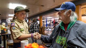 Scouts from Ashland Troop 112 shake hands with Tim Hernandez Sr., a veteran and former scoutmaster, at the 2023 Veterans Day breakfast. Troop 112 has been involved with serving Veterans Day breakfasts to former service members since 2017. Ashland.news photo by Bob Palermini