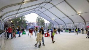 Skaters glide on the Ashland Rotary Centennial Ice Rink in 2023. The city-owned rink’s season is in jeopardy as officials await a required engineering sign-off for its canopy. Ashland.news photo by Bob Palermini