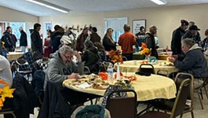 Tables start to fill up as diners fill their plates in 2024 at the Thanksgiving Community Peace Meal. Debora Gordon photo for Ashland.news