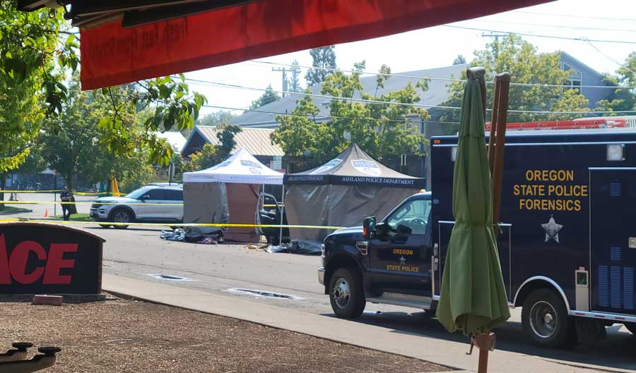 A pair of pop-up tents across A Street from Ashland ACE Hardware protect evidence in the case of an early morning shooting Sunday that left an Ashland man dead. Art Van Kraft photo