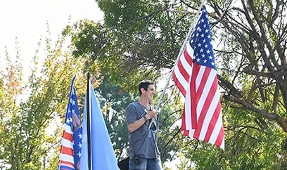 Medford resident Logan Vaughn, a former political candidate, helped coordinate Saturday’s memorial ride and led the crowd in a prayer and then the Pledge of Allegiance. Rogue Valley Times photo by Buffy Pollock