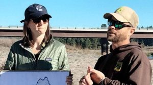 Melaney Dunne, conservation manager with the Wild Salmon Center, holds a sign showing salmon sightings while Oregon Department of Fish and Wildlife biologist Mark Hereford explains documented salmon sightings. Scientists from Mongolia spent three days touring areas along the Klamath River to learn about learn about the impacts of dam removals and the impacts on salmon. Gary Vequist photo
