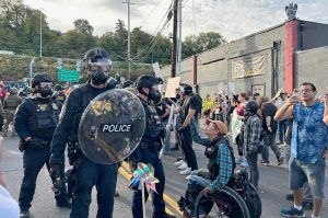 About 200 people showed up to protest outside the Immigration and Customs Enforcement building in Portland on Sunday, Sept. 28, 2025. The 9th Circuit Court of Appeals voted Tuesday, Oct. 28, to review a decision that cleared the way to deploy National Guard troops. Oregon Capital Chronicle photo by Alex Baumhardt