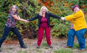 Camelot Theatre Artistic Director Gwen Overland is tugged in two directions by the witches of "Hansel & Gretel: A Panto Tale." Jade Chavis, left, will portray the Forest Witch, La Befana, and and Mason Rudesheim will play the Wicked Witch in the musical production at the Camelot. Overland wrote the script and will direct.