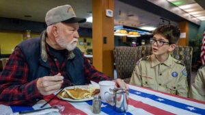 Leon Mosley, left, an Army veteran, talks with Scout Solomon about his service during the annual Veterans Day breakfast. Ashland.news photo by Bob Palermini