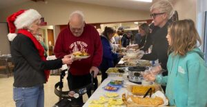 State Rep. Pam Marsh, left, smiles while assisting an individual with his plate during the eighth annual Holiday Peace Meal in 2023. This year she is signed up to help serve and provide food for the 2025 Holiday Peace Meal from 1 to 3 p.m. Dec. 20 at First Presbyterian Church of Ashland. Ashland.news file photo by Holly Dillemuth